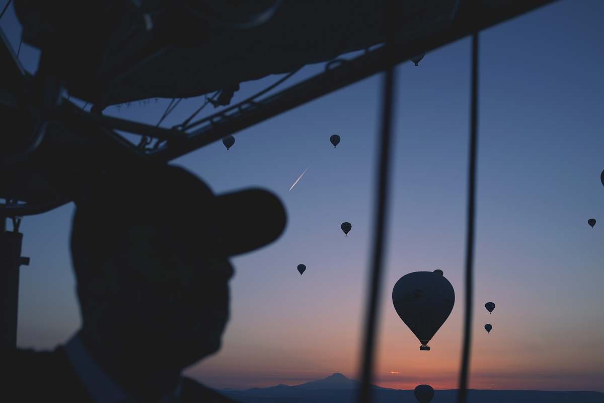 hot air balloon silhouette of person with hot air balloon in the air man